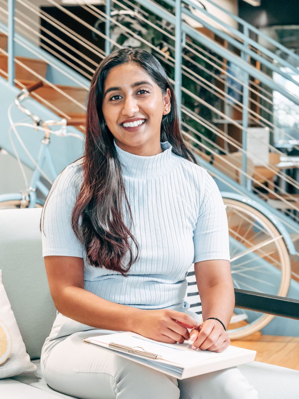 Smiling young Indian professional woman in a modern office